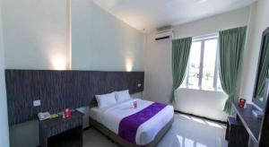 a bedroom with a large bed and a window at Salsa Resort Langkawi By Casa Loma in Pantai Cenang