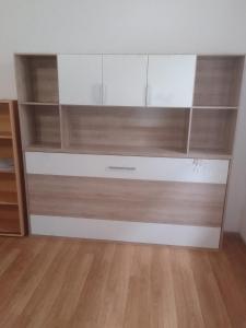 a dresser with wooden shelves in a room at Apartmány Pražská in Ústí nad Labem