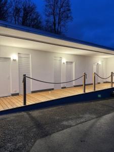 a building with a deck with lights on it at Edersee Apartment Seeblick 2 in Waldeck