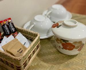 a table with two baskets and a tea pot at Acacia Garden Inn in Coron