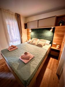a bedroom with a large bed with two towels on it at Mobile home TASHA in Biograd na Moru