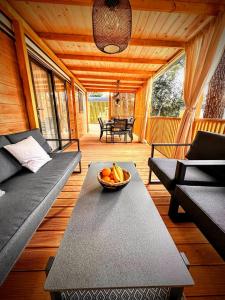 a living room with a bowl of fruit on a table at Mobile home TASHA in Biograd na Moru +26 photos