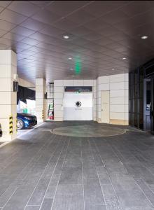 a parking lot with a car garage with a white wall at Sota stay Hotel in Seoul