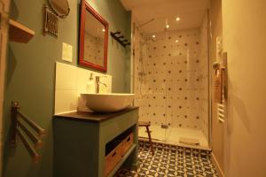 a bathroom with a sink and a shower at La Haute Flourie - bed and breakfast -chambres d'hôtes in Saint Malo