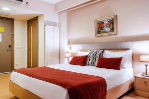 a bedroom with a large white bed with red pillows at Cheya Besiktas Hotel & Suites- Special Category in Istanbul