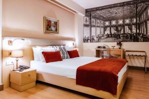 a bedroom with a bed with a painting on the wall at Cheya Beşiktaş Istanbul Bosphorus City Center Hotel & Suites in Istanbul