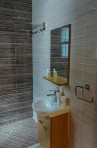 a bathroom with a sink and a mirror at The Wave Villa - Fujairah in Fujairah
