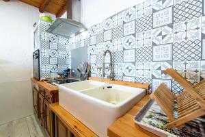 a bathroom with a large white sink and blue tiles at Appartement Albiez Montrond in Albiez-Montrond +17 photos
