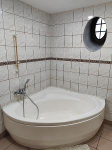 a bath tub in a bathroom with a window at Apartament dla dwóch osób - Piotrkowska 262-264 pok A101 in Łódź