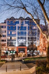 a large building with people walking in front of it at Cheya Beşiktaş Istanbul Bosphorus City Center Hotel & Suites in Istanbul