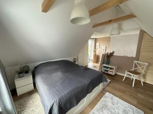 a bedroom with a bed and a chair in a room at Ferienwohnungen Stilschön in Warnemünde