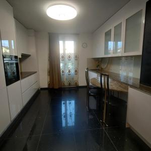 a kitchen with a counter and a table and a window at Butthouse Apartments in Trimbach