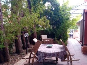 uma mesa e cadeiras num pátio com árvores em Villa venere e spa em Palermo