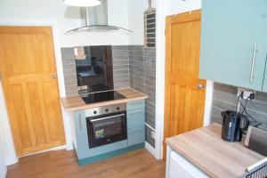 a small kitchen with a stove and a sink at Lily's Place in Cleethorpes
