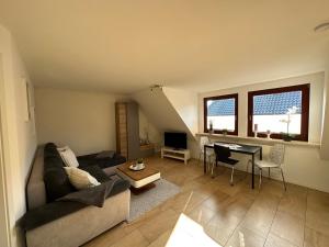 a living room with a couch and a table at Ferienwohnungen Stilschön in Warnemünde