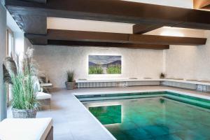a swimming pool in a house with a pool at Hotel Bachmair Alpina in Rottach-Egern