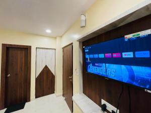 a large television on a wall in a room at Mohor Inn in Kharagpur