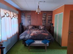 a bedroom with a large bed with orange walls at Traditional House Rovaniemi in Rovaniemi