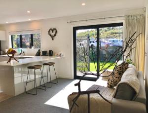 a living room with a couch and a kitchen at Fashion,Bright and Spacious,Superior location in Hamilton