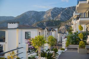 a row of houses with mountains in the background at Antique Hills in Alanya