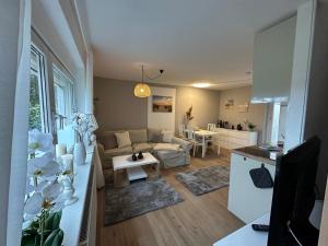 a living room with a couch and a table at Ferienwohnungen Stilschön in Warnemünde