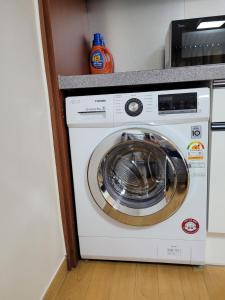 a white washer and dryer in a room at White Stay in Seoul