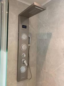 a shower with a control panel in a bathroom at Proche Disney ! in Meaux