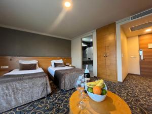 Pokój hotelowy z 2 łóżkami i stołem z misą owoców w obiekcie Volley Hotel İzmir w mieście Konak