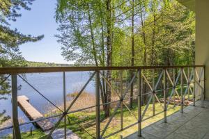 a balcony with a view of a lake at Pussala in Daugavpils