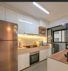 a kitchen with a stainless steel refrigerator in it at Schemes Hotel And Apartment in Port Harcourt