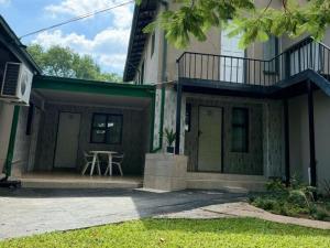 a house with a porch with a table and a balcony at Dula Monate Holiday Flats in Bela-Bela