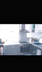 a kitchen with a stove and a stove top oven at Charmante maison de ville in Lyon