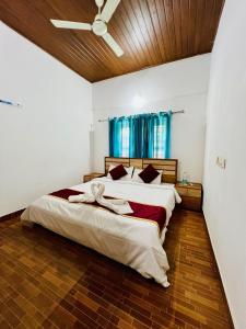 a large bedroom with two beds and a window at The Stream View Villas Wayanad in Vythiri
