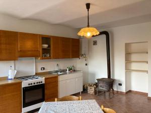 a kitchen with a sink and a stove top oven at Casa nella natura a Bobbio in Bobbio