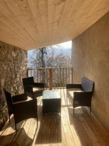 a room with chairs and a table on a balcony at Casa nella natura a Bobbio in Bobbio