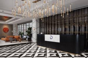 a lobby with a reception desk and a chandelier at Delta Hotels by Marriott Istanbul Kagithane in Istanbul