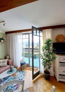 a living room with a couch and a sliding glass door at Ferienwohnung "Glücksplatzerl" in Mondsee