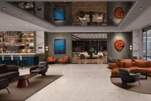 a lobby with couches and chairs and a bar at Delta Hotels by Marriott Istanbul Kagithane in Istanbul