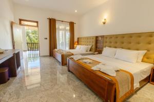 丹不拉Elysia Sigiriya Hotel的一间卧室，有两张床，床上有毛巾