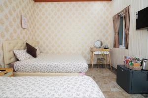 Postel nebo postele na pokoji v ubytování Xing City Hotel Dalat