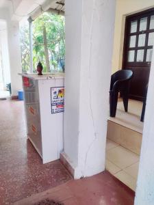 a room with a table and a black chair at Euphoria Stays in Anjuna in Anjuna