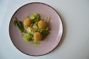 a plate of food with broccoli and meatballs at Eko Hotel Na Wierzynka & Park Pinokia in Wieliczka