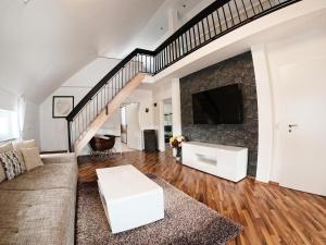 a living room with a couch and a tv at Ferienwohnung im Allgäu in Durach