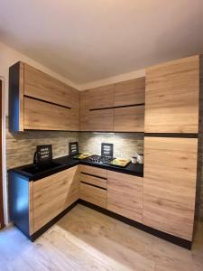 a kitchen with wooden cabinets and a black counter top at Sogno sul lago in Capodimonte +38 photos