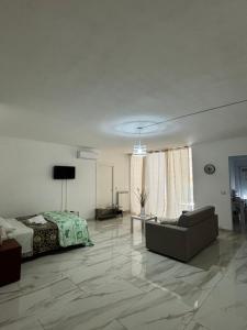 a living room with a bed and a couch at Sol Casa in Cosenza