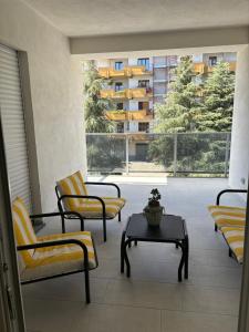 a room with chairs and a table and a large window at Sol Casa in Cosenza