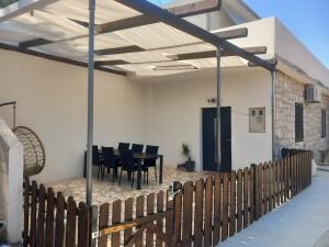 a patio with chairs and a table in a building at Fisherman's House in Skrivena Luka