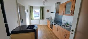 a kitchen with a sink and a counter top at Ferienwohnung Wallersee in Neumarkt am Wallersee