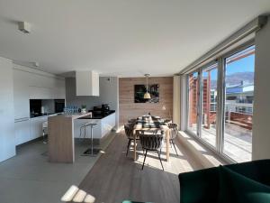 a kitchen and living room with a table and a large window at Apartament ZETA - CITY 2 in Ustroń