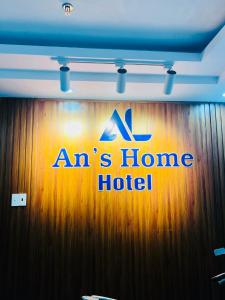 a sign on a wood wall with an ahs home hotel at An's Home Hotel Vũng Tàu in Vung Tau